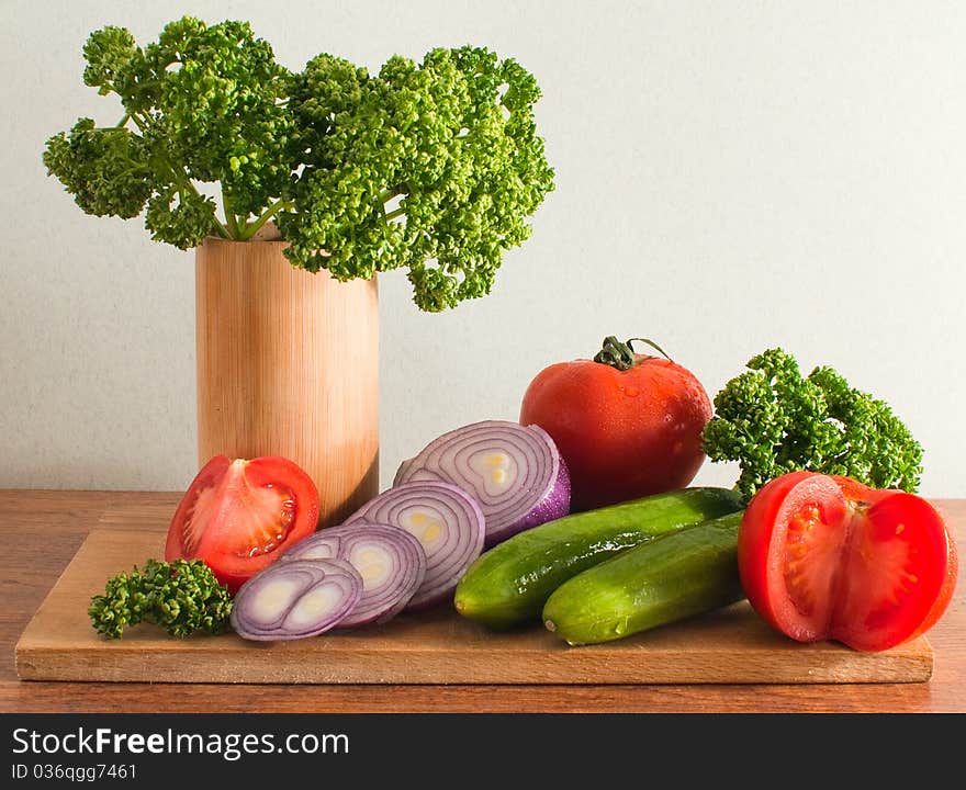 Still life of vegetables and herbs on a cutting board