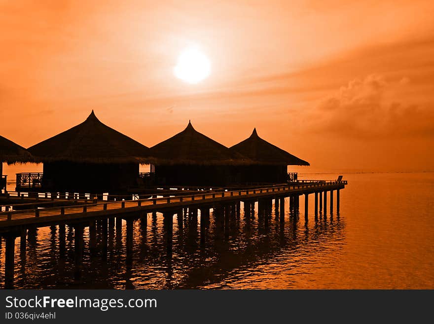 Water bungalows and sunset - abstract vacation background