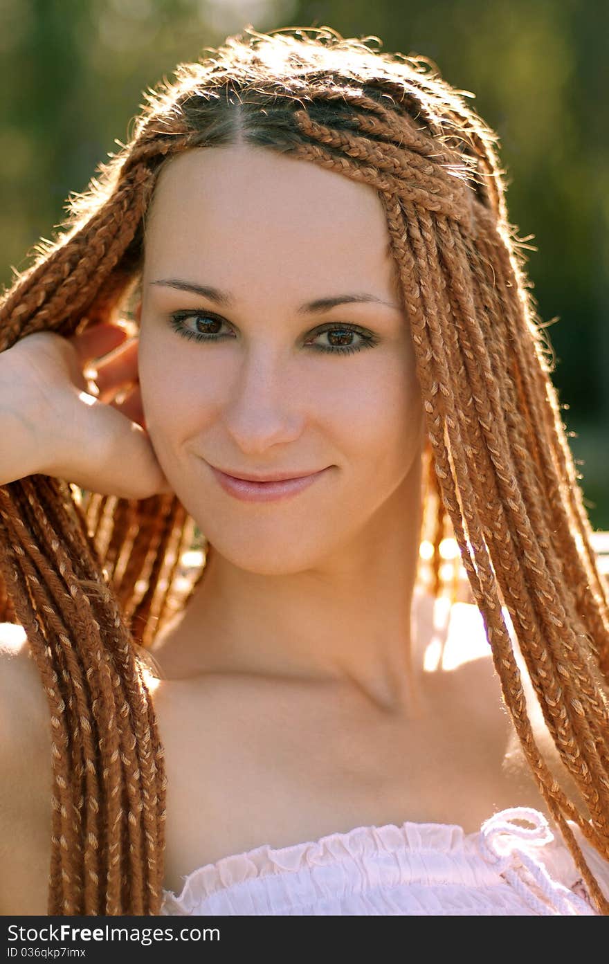 Beautiful girl with pigtails in the park summer morning. Beautiful girl with pigtails in the park summer morning