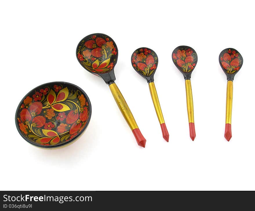 Painted wooden spoons and cup on a white background