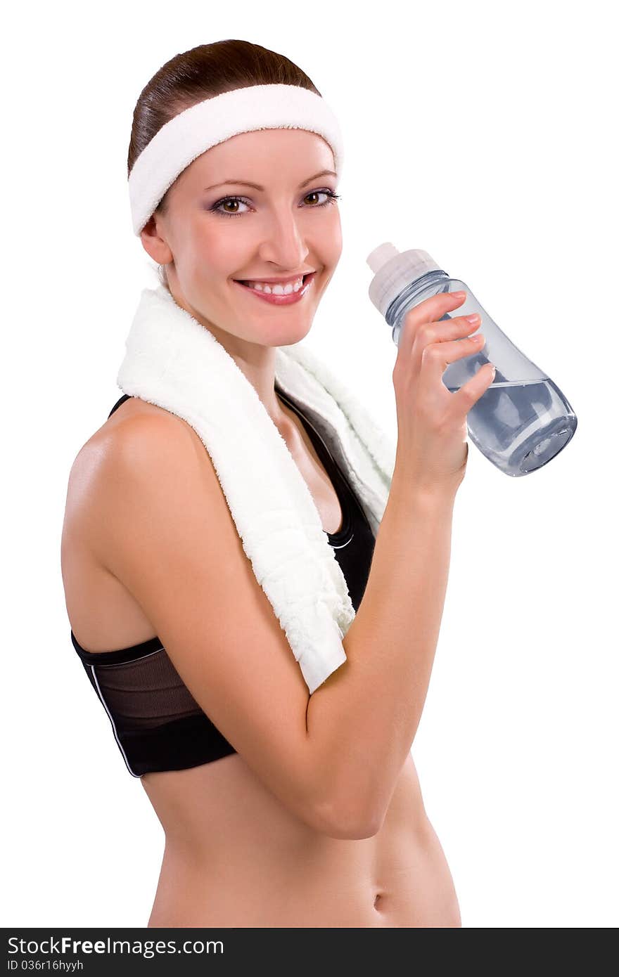 Beautiful young athlete with bottle of water and towel on her shoulders. Beautiful young athlete with bottle of water and towel on her shoulders