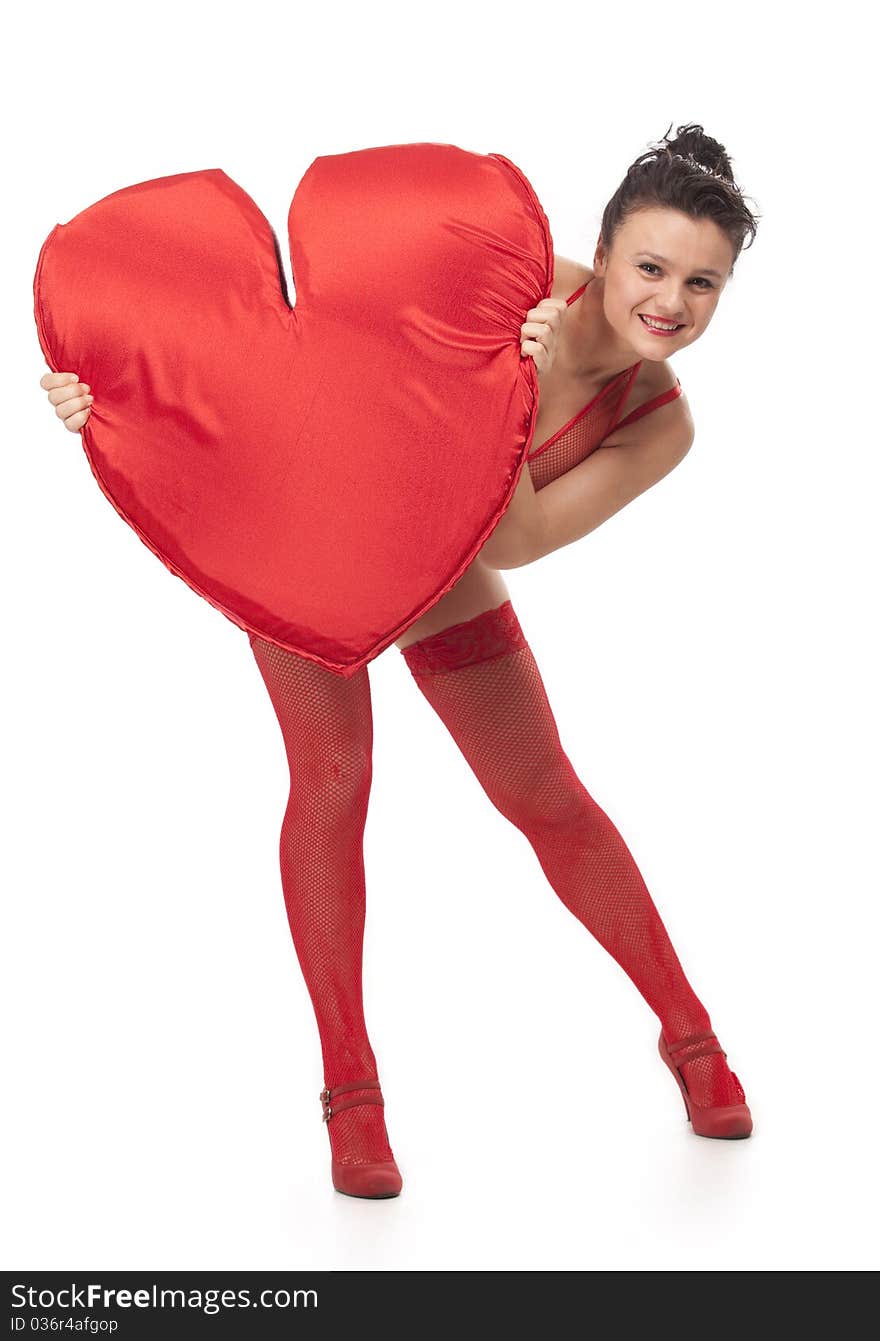 Young woman in red lingerie holding big Heart over white. Young woman in red lingerie holding big Heart over white