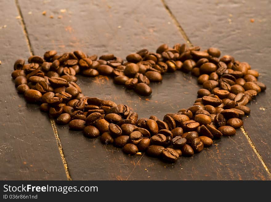 Coffee beans heart on wood background