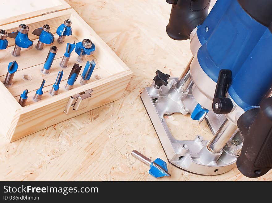 Mills and a milling cutter on a tree on a wooden table