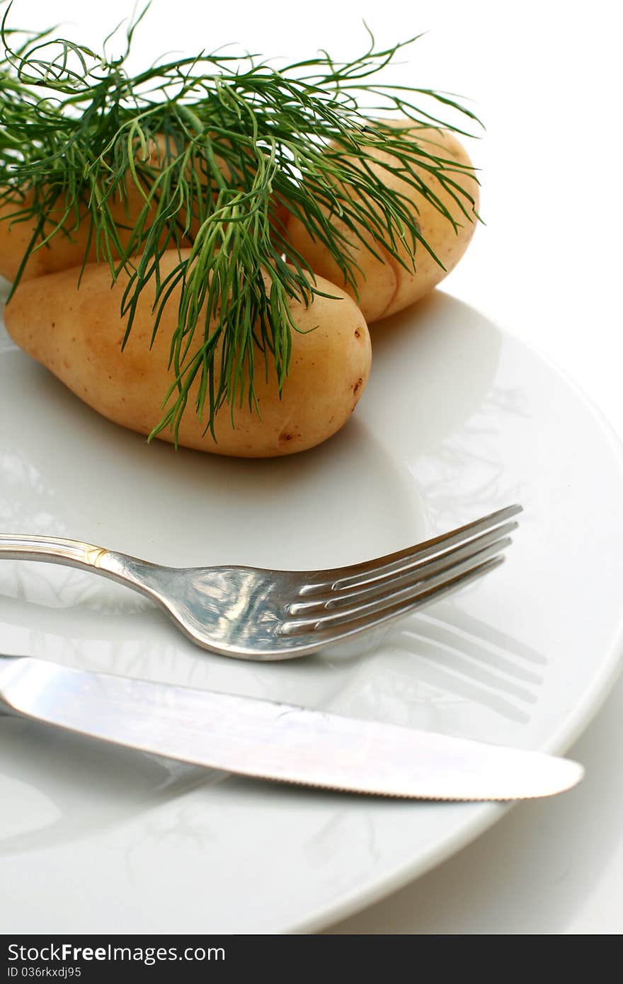 Potatoes and plate isolated over white background. Potatoes and plate isolated over white background.