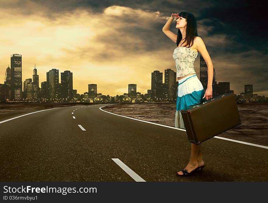 Young woman waiting on the road with her vintage baggage. Young woman waiting on the road with her vintage baggage