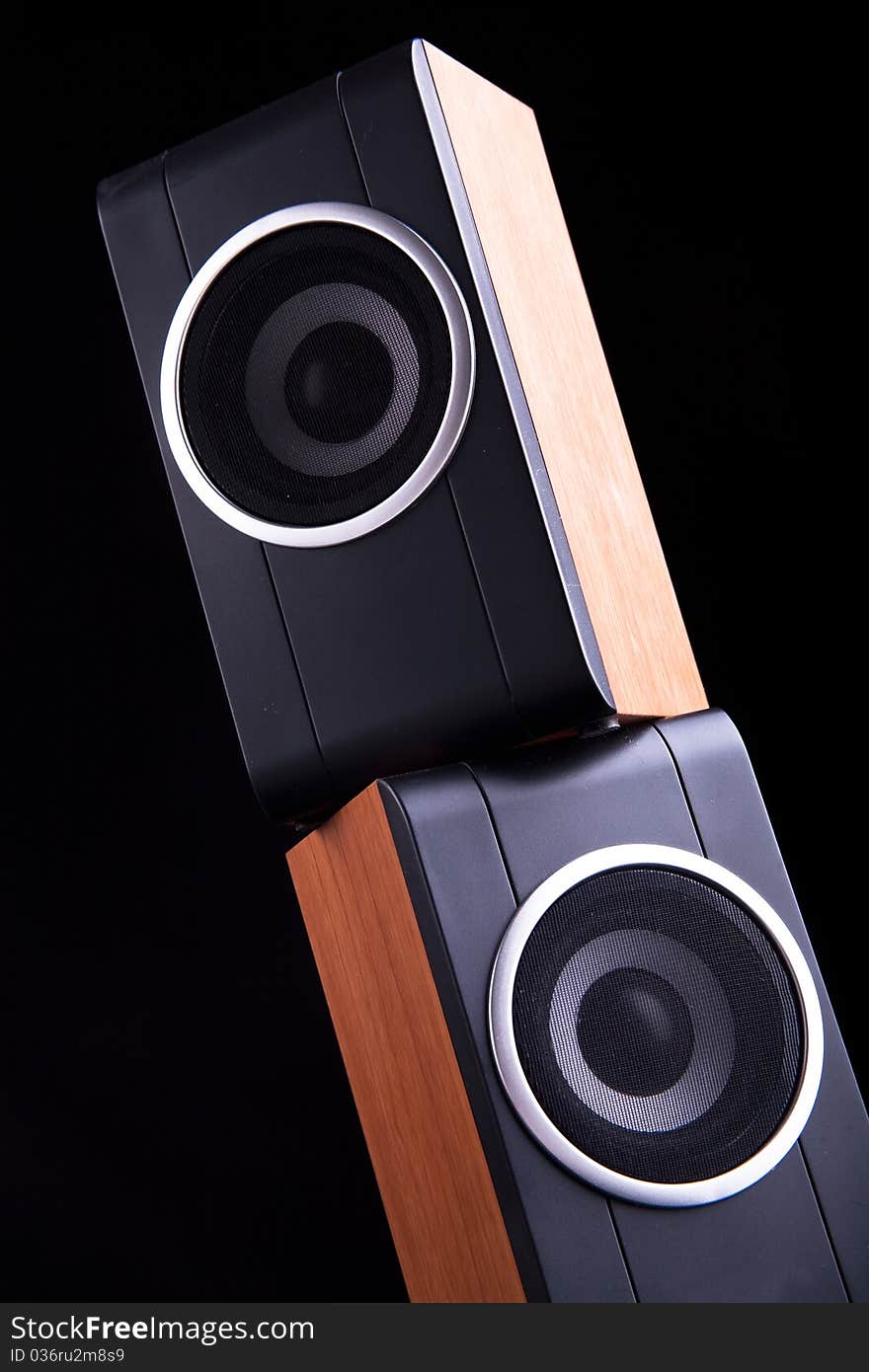 Two computer wood speakers on dark background. Two computer wood speakers on dark background