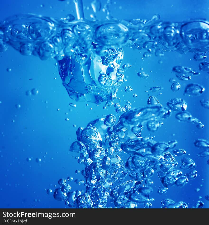 Blue water splash bubbles macro close up