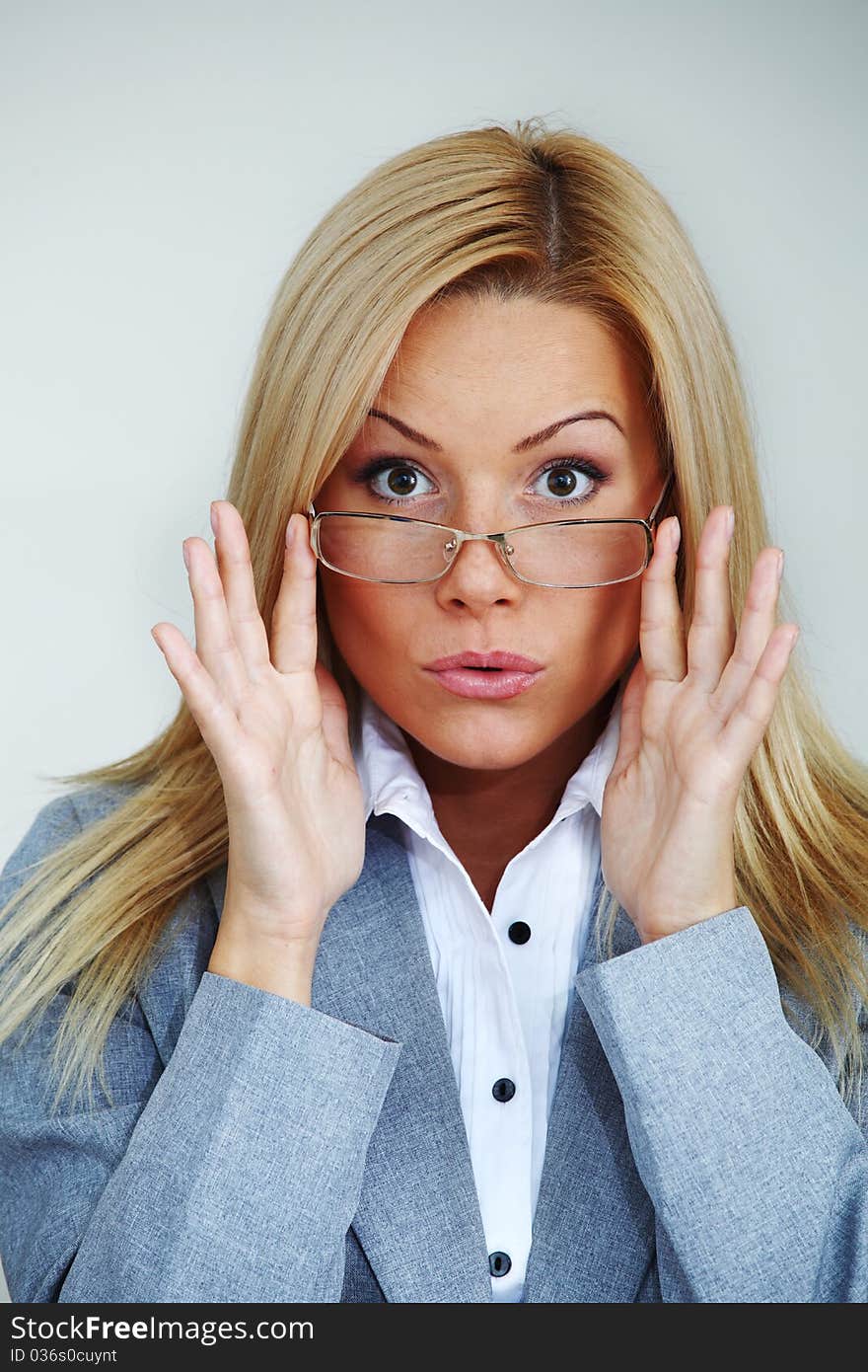 Business woman in glasses on gray background