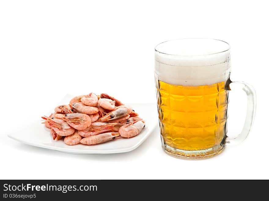 Fresh, cold beer in glass and fried shrimps on plate. Isolated on white. Fresh, cold beer in glass and fried shrimps on plate. Isolated on white