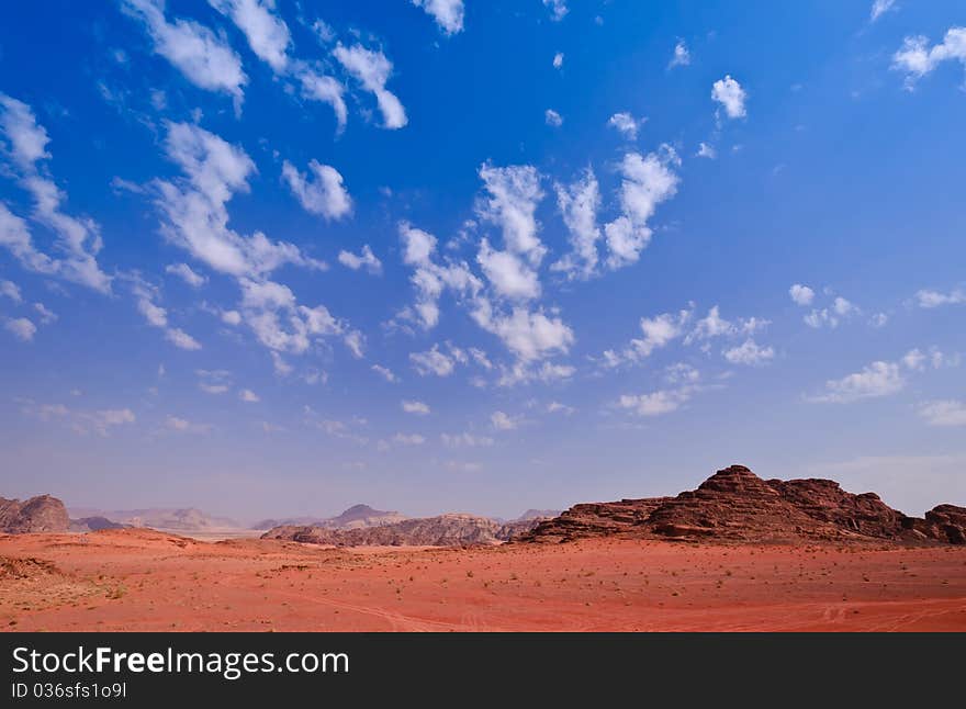 Wadi Rum is stunning in its natural beauty with its moonscape of ancient valleys and towering sandstone mountains rising out of the sand.