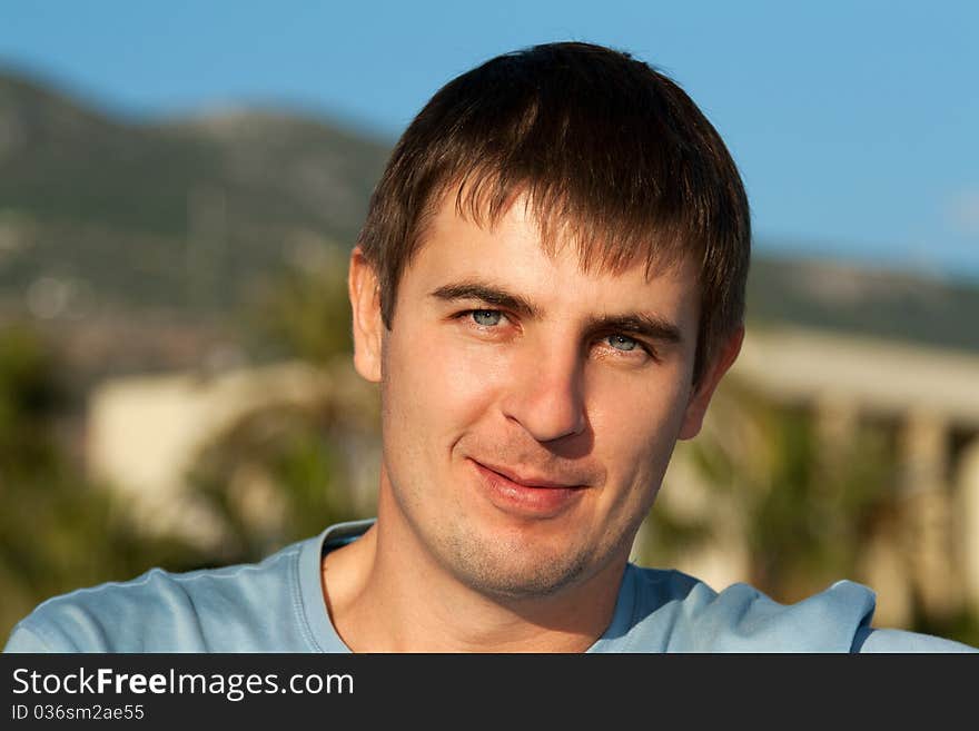 Portrait of a man against the backdrop of greenery