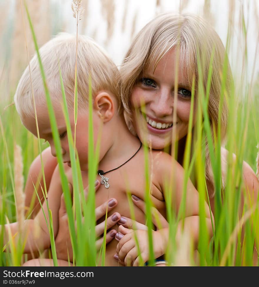 Happy mother and son in green grass