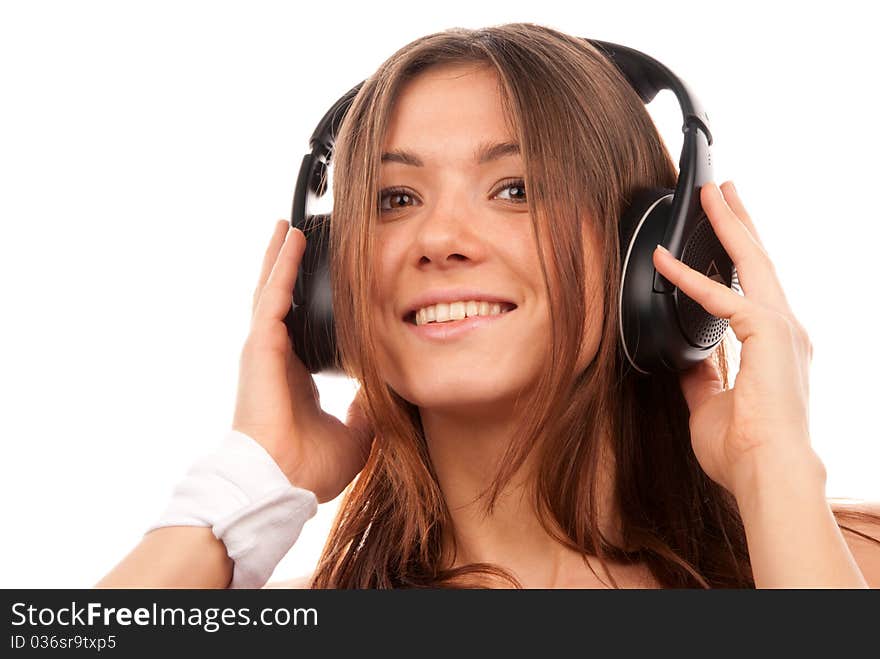 Pretty young DJ woman listening music in big headphones on mp3 player smiling and laughing isolated on white background