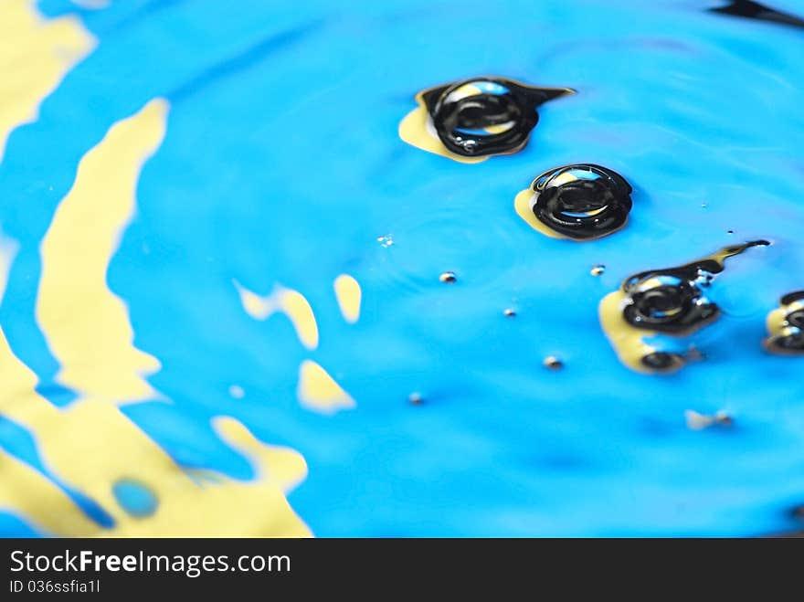 Colored drops on the water surface