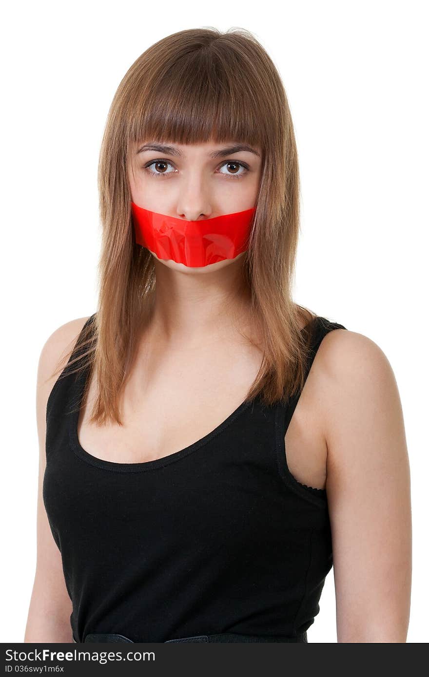 Beautiful girl with her mouth sealed with red tape