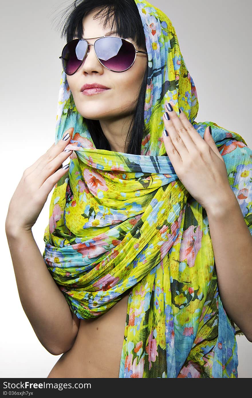 The beautiful girl in a motley scarf