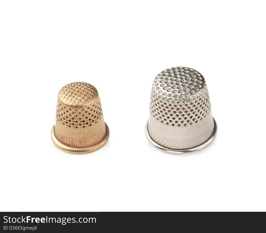 Old cooper and metal thimbles isolated on a white background