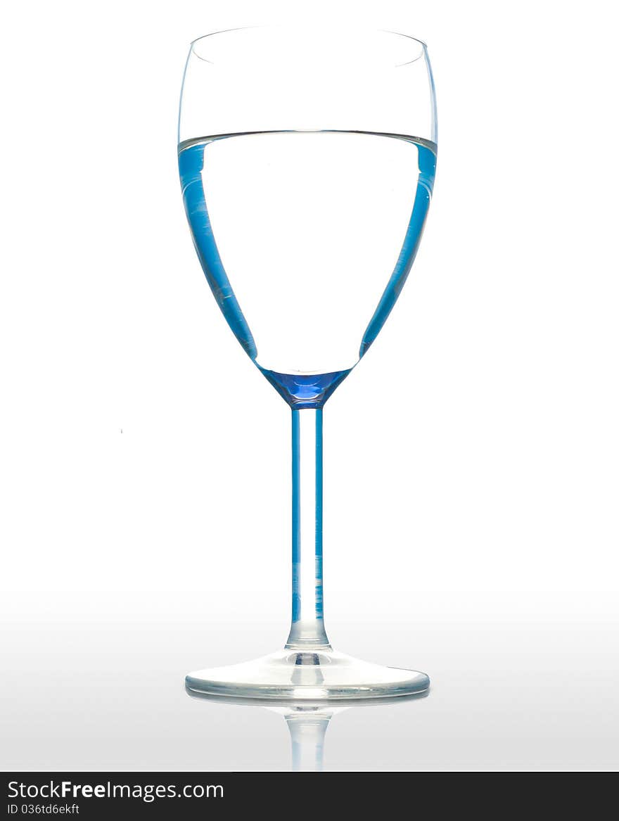 Water in a wineglasse on a wite background. Water in a wineglasse on a wite background.