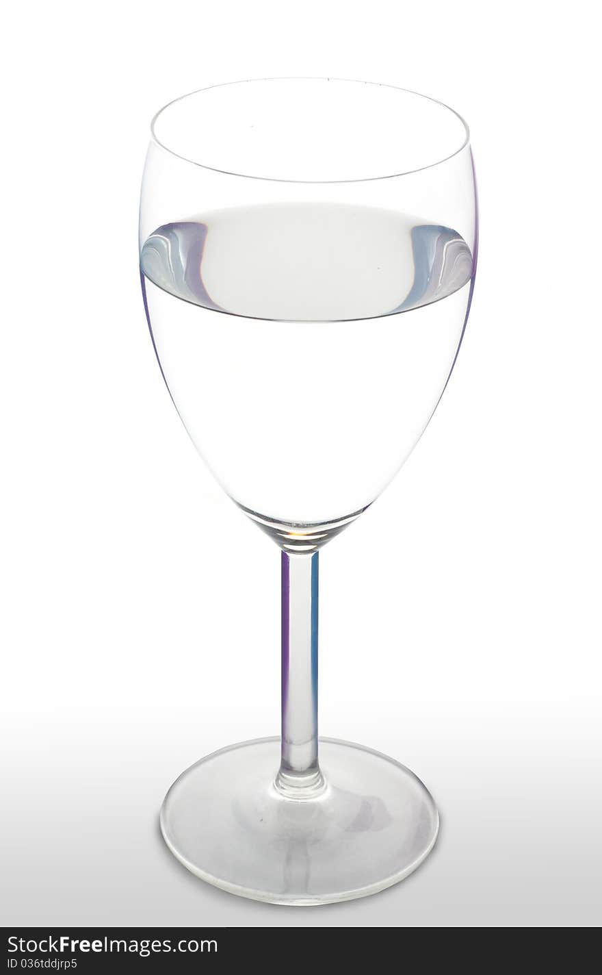 Water in a wineglasse on a wite background. Water in a wineglasse on a wite background.