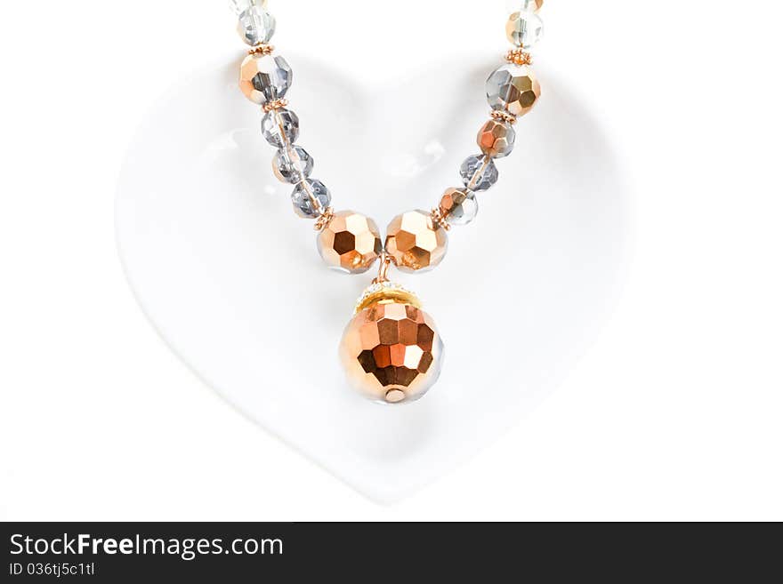 Jewel necklace on heart shaped saucer