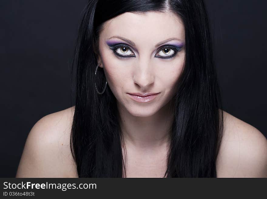 Attractive brunette woman with blue and purple makeup