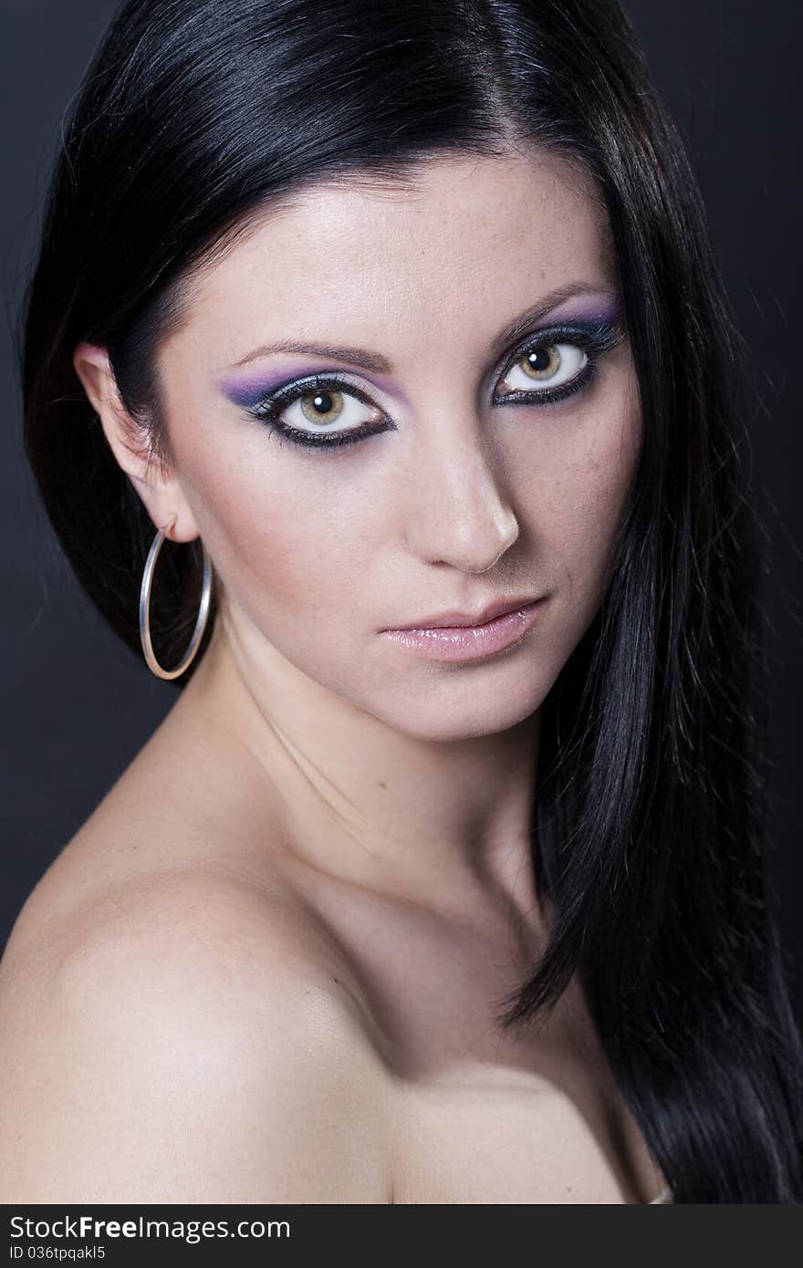 Attractive brunette woman with blue and purple makeup