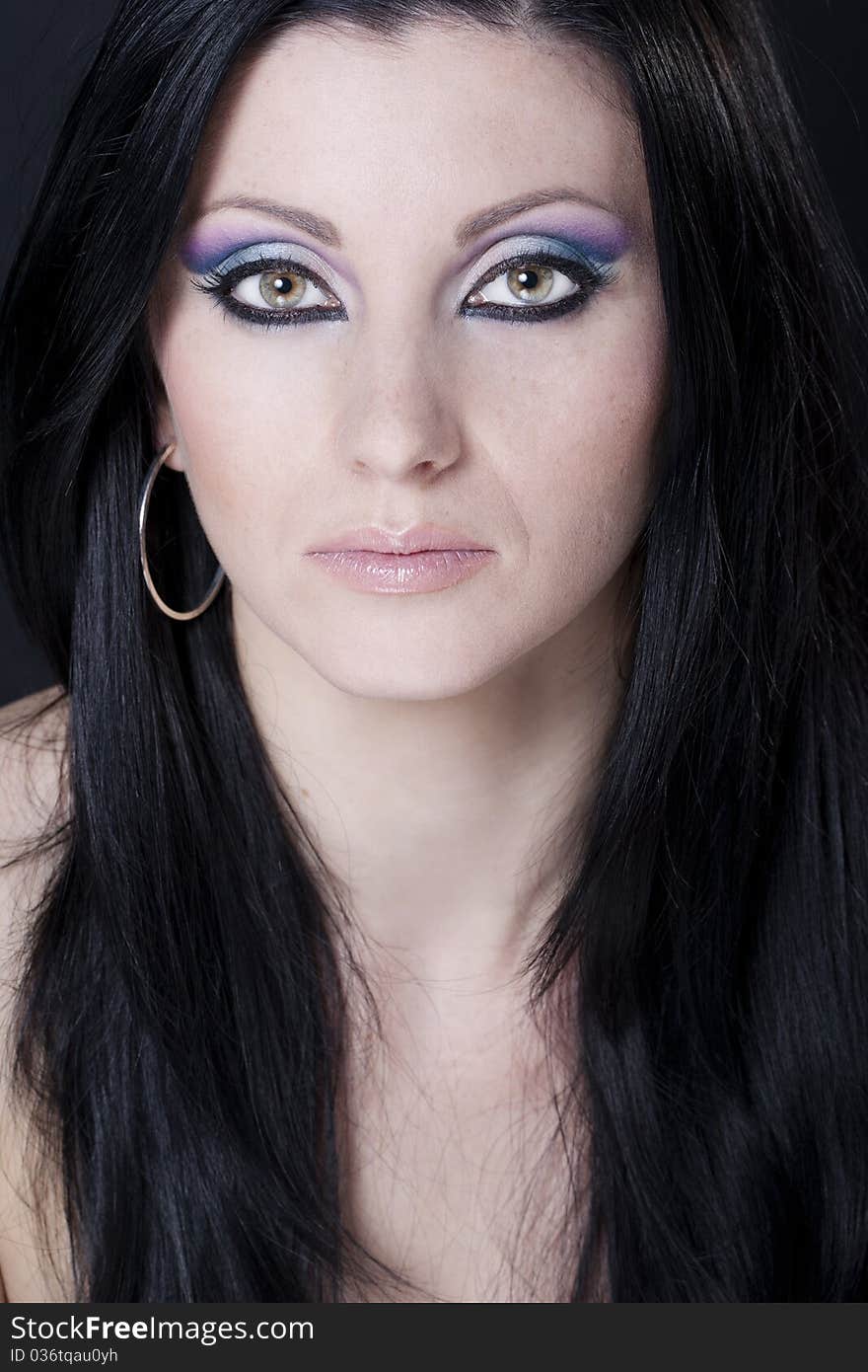 Attractive brunette woman with blue and purple makeup