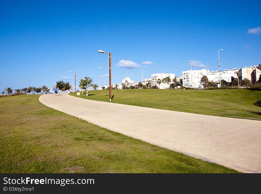 Footpaths in the park against the backdrop of the city. Footpaths in the park against the backdrop of the city