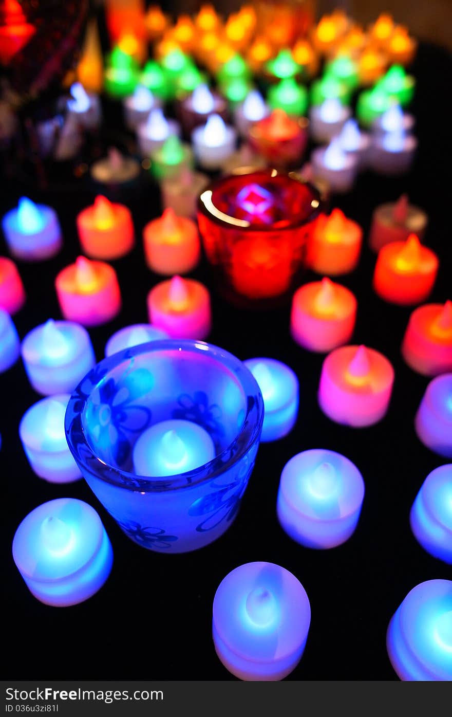 Candle with colorful defocussed lights. A perfect festive background. Candle with colorful defocussed lights. A perfect festive background.