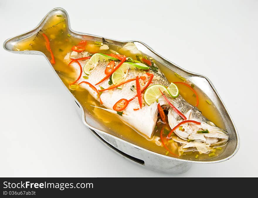 Steamed snapper fish with lemon on white background