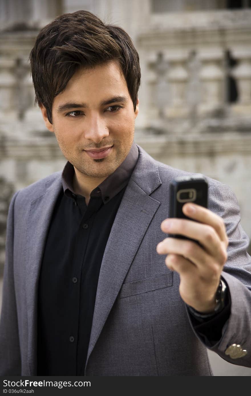 Young business man reading a message. Young business man reading a message.