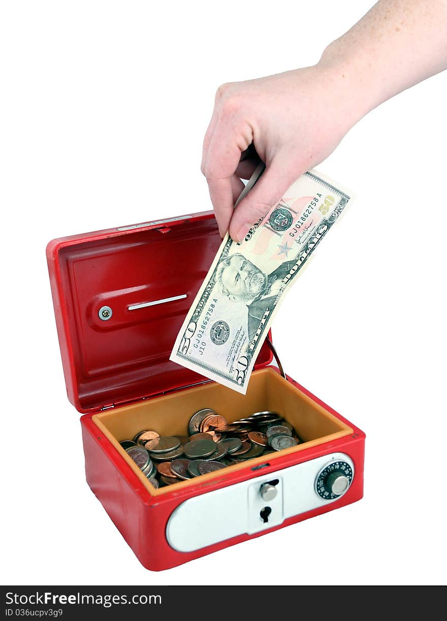 Placing a $50 bill into a safe. Placing a $50 bill into a safe