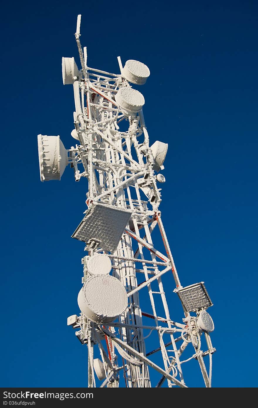 The top of a GSM antenna tower, covered in snow. The top of a GSM antenna tower, covered in snow