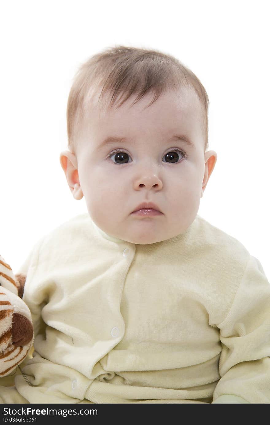 Lovely brown-eyed baby sits (lies) on white fur. Lovely brown-eyed baby sits (lies) on white fur