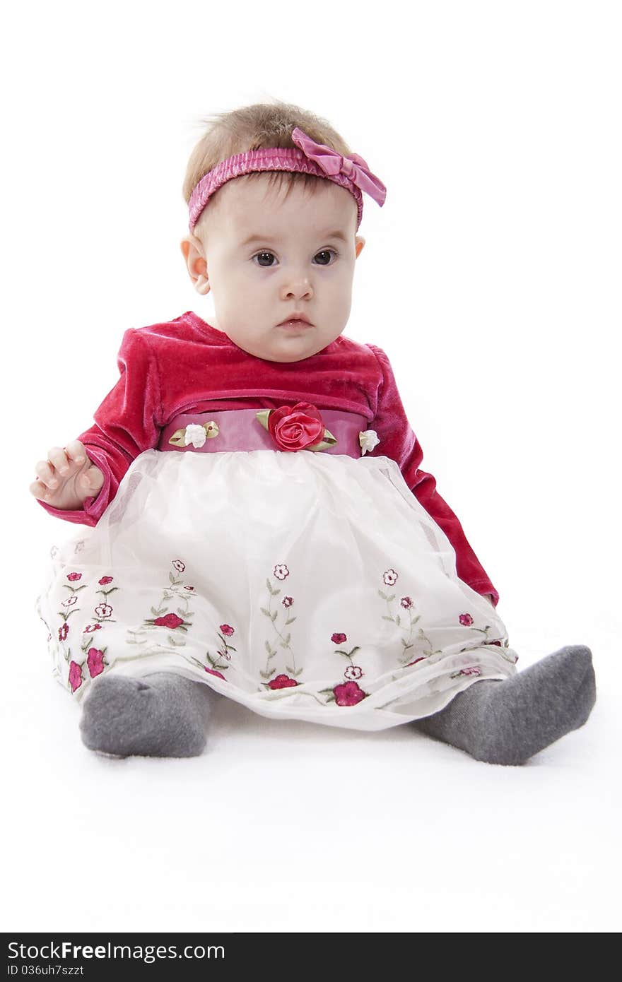 Portrait of sitting little girl isolated on white. Portrait of sitting little girl isolated on white.