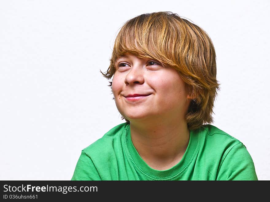 Smiling boy sitting on a sofa at home