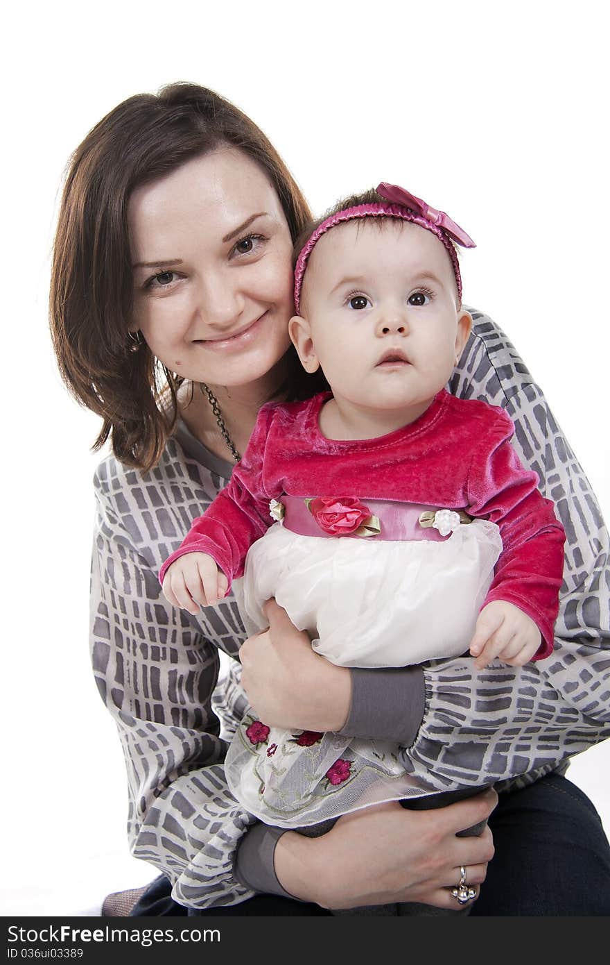 Mother with her sweet little daughter isolated on white. Mother with her sweet little daughter isolated on white.