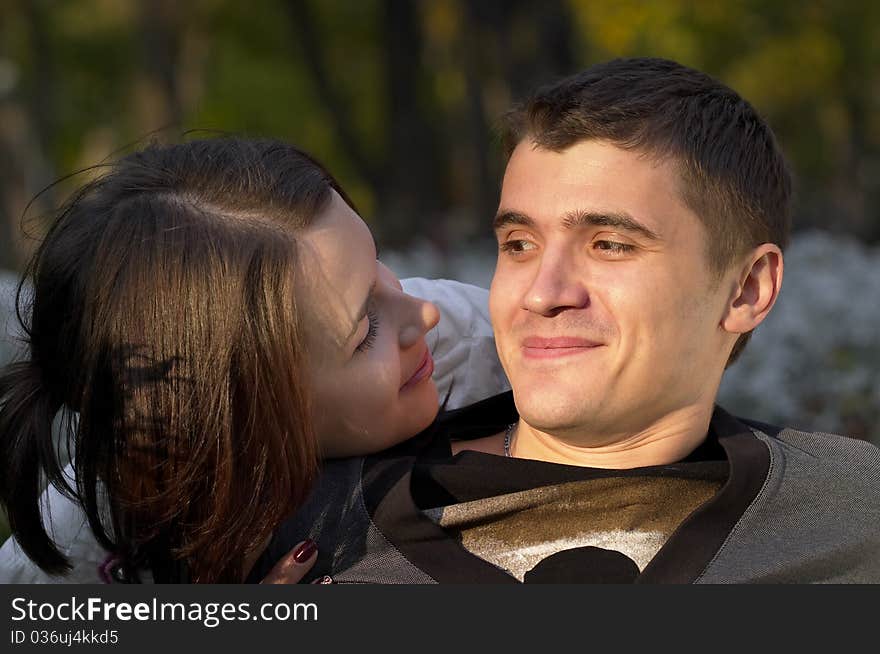 Young couple looking at each other eyes over defocused background. Young couple looking at each other eyes over defocused background