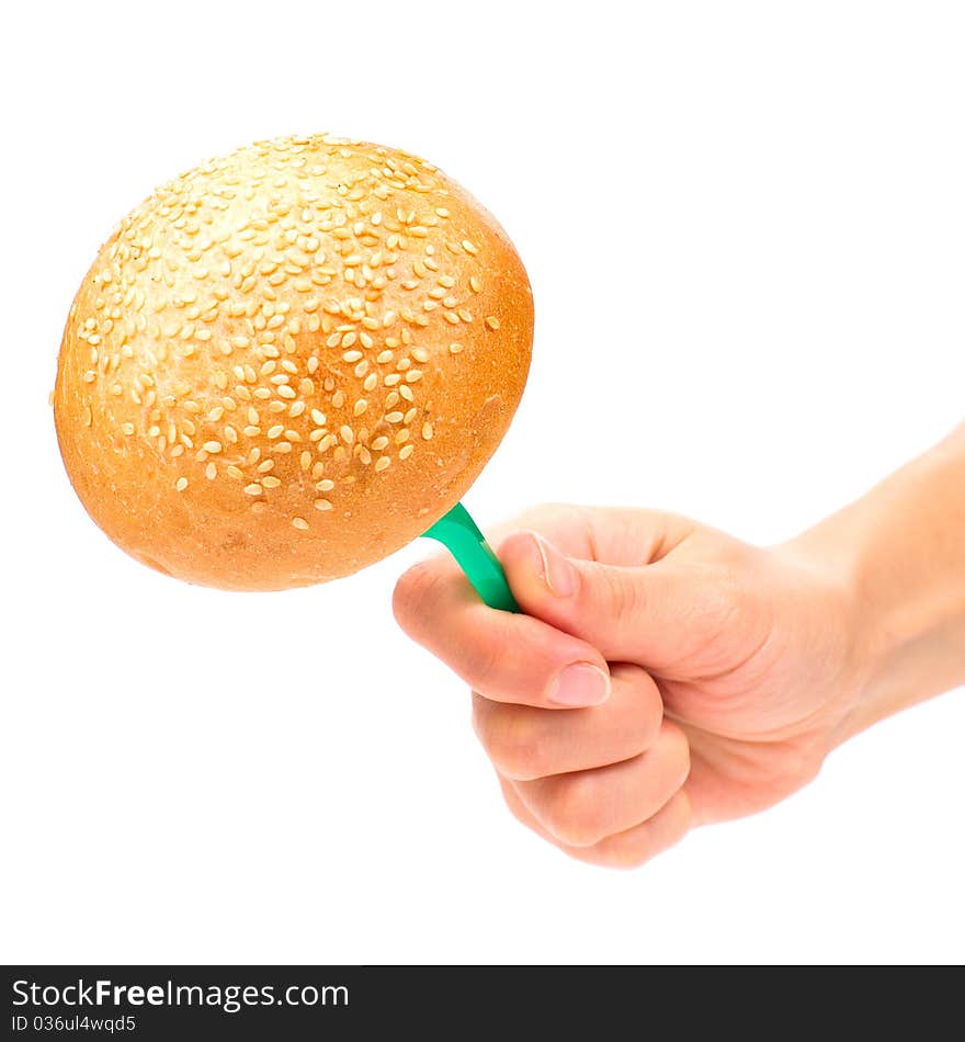 Hand holding a bun on the fork isolated on the white background. Hand holding a bun on the fork isolated on the white background