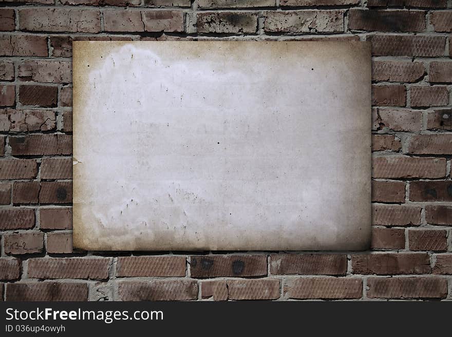 Old paper on brickwall, vintage background