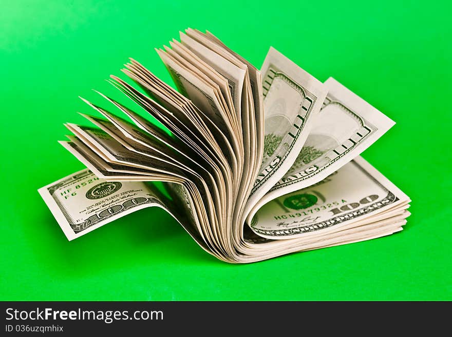 100 dollar bills on a green background. 100 dollar bills on a green background