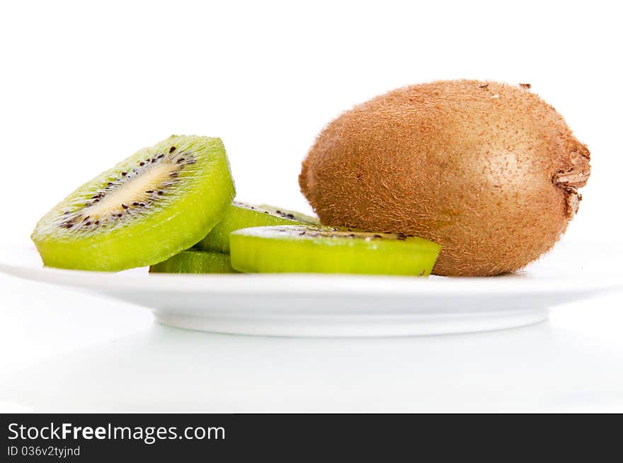 A plate with fresh kiwi isolated on white background