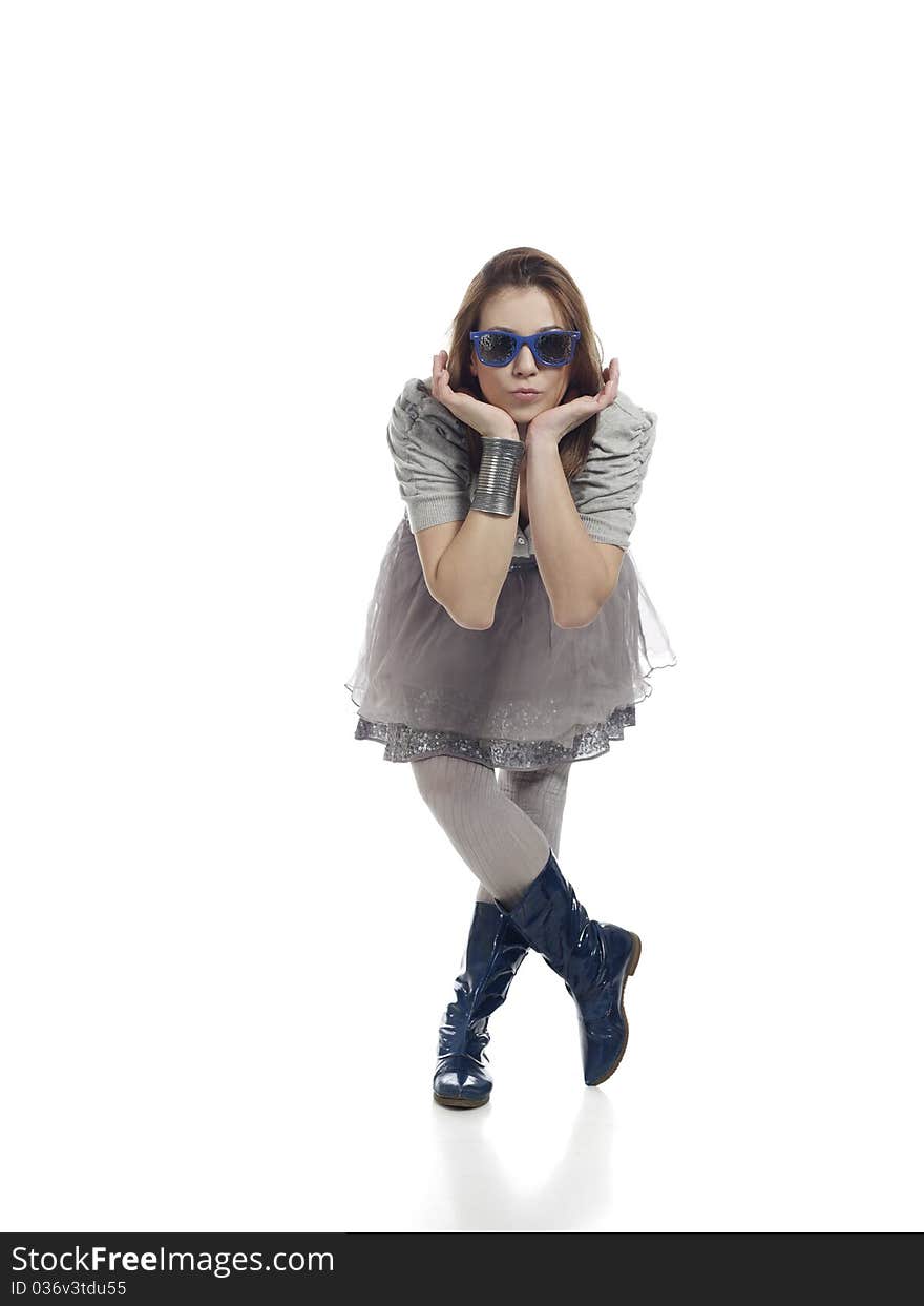 Young woman in cool clothes posing, holding her head with her hands against white background. Young woman in cool clothes posing, holding her head with her hands against white background