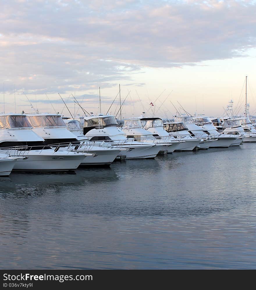 Row of docked boats and yachts at Sunset