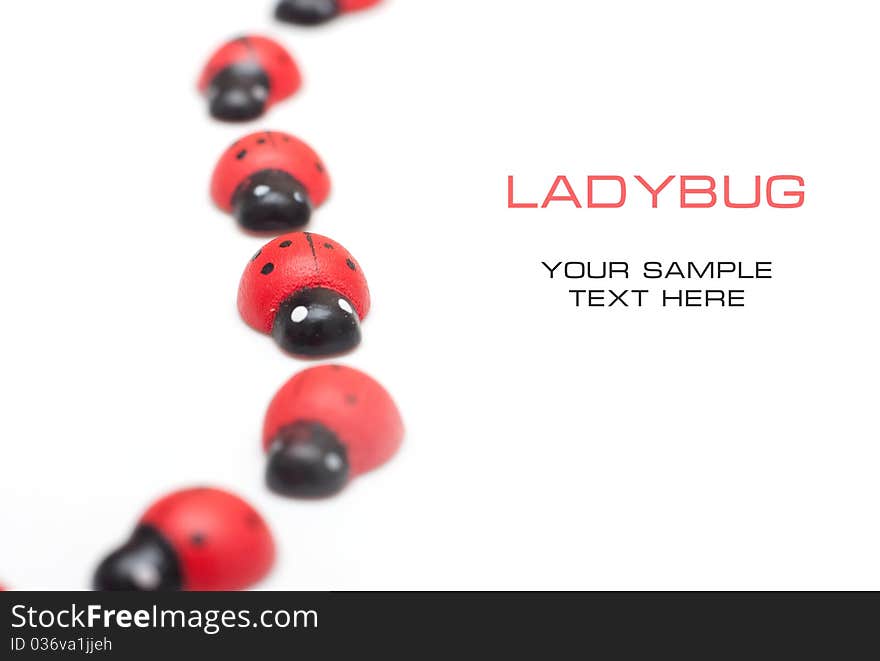 Small decorative ladybugs on a white background with space for text. Small decorative ladybugs on a white background with space for text