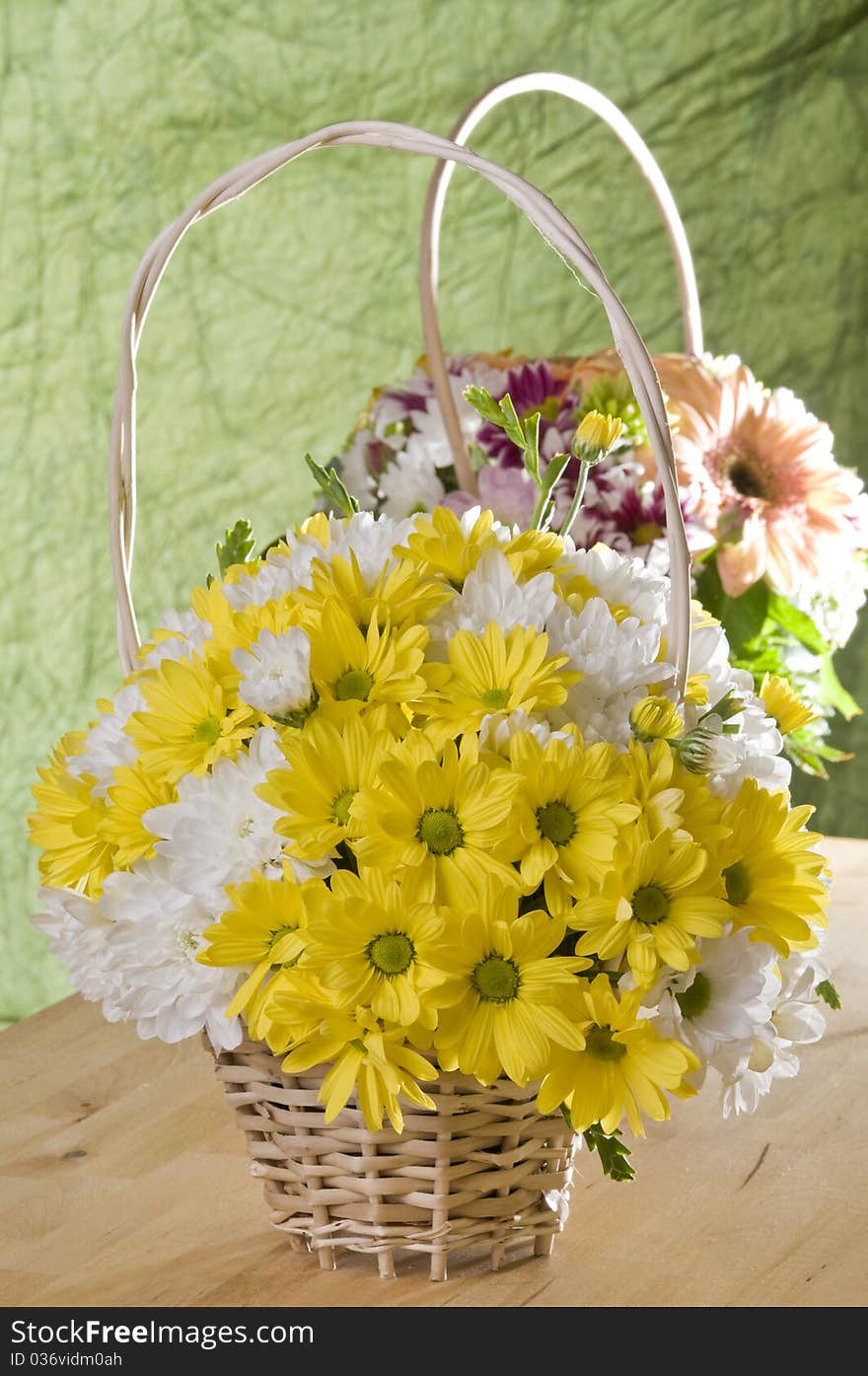 Flowers in a basket over green textured background. Flowers in a basket over green textured background