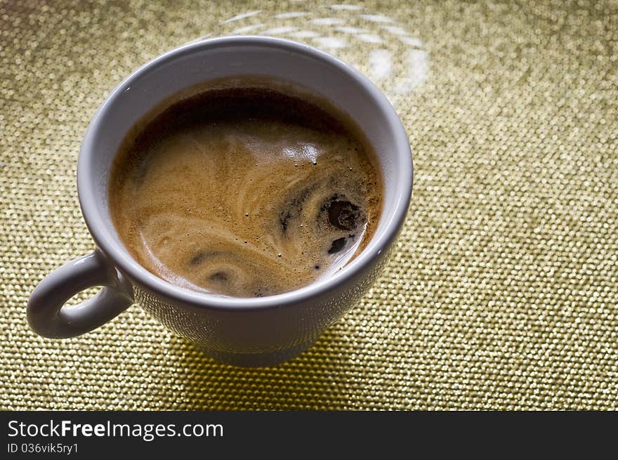 Cup of coffee with froth on a plate. Cup of coffee with froth on a plate