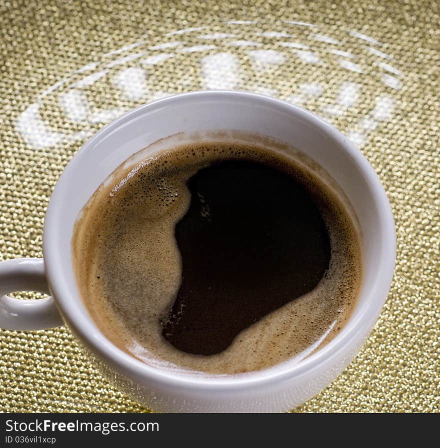 Cup of coffee with froth on a plate. Cup of coffee with froth on a plate