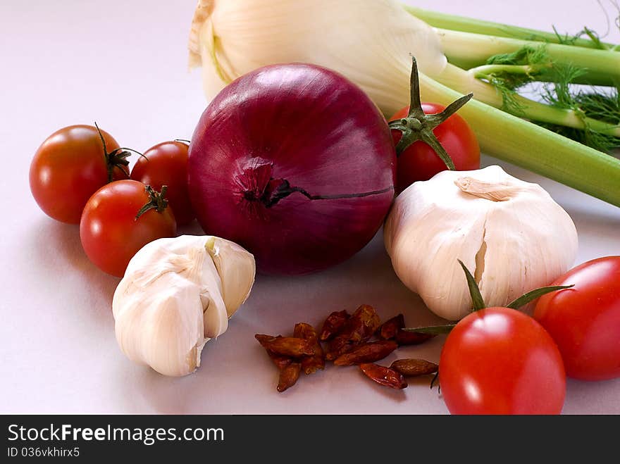 Tomatoes, garlic, onion, fennel and pepper with grey background. Tomatoes, garlic, onion, fennel and pepper with grey background